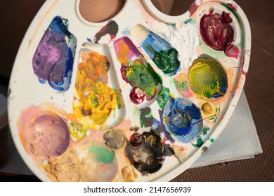 A Woman's Hands Mixing Paints On A Palette Board. Preparing To Paint A Picture. Artistic Tools. The Creative Process.