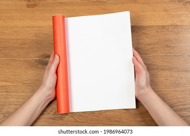 Woman's Hands Open Empty Catalog, Magazines, Book Mockup On Wooden Table