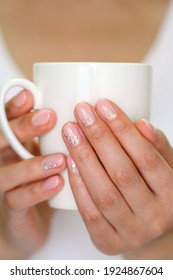 Woman's Hands With Organic Gel Nails Holding A Mug