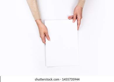 Woman's hands with perfect manicure holding  notepad as mockup for your design. White background, flat lay 