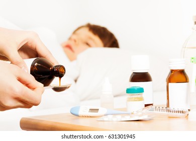 Woman's Hands Pouring Antipyretic Syrup For Kid