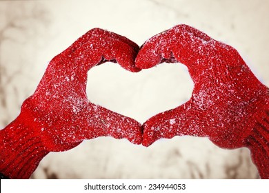 Woman's Hands In Red Gloves On Winter Natural Background