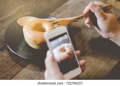 Woman's Hands Relaxing With Donut At Donut Shop Women, Smartphone Take Pictures Before Eating