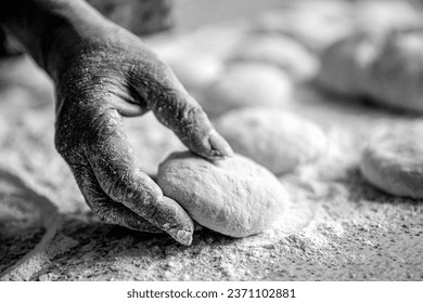 Womans hands rolling dough for pies. Baking at home. Homemade cakes dough in the women's hands. Process of making pies. Black and white. - Powered by Shutterstock