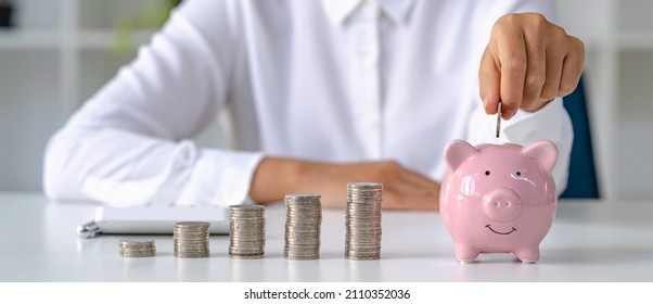 Woman's Hands Saving Money In Piggy Bank, Saving Money For The Future For Retirement Savings From Work, Investment Savings Ideas