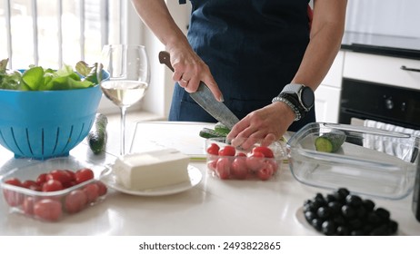 Woman'S Hands Are Slicing Cucumber For Greek Salad With A Glass Of White Wine Nearby - Powered by Shutterstock