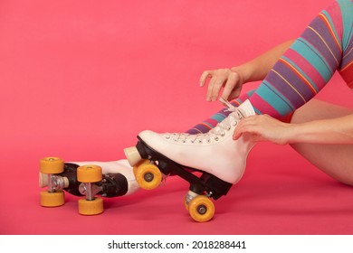 Woman's Hands Tying The Laces Of Her 4-wheeled Skate Boots