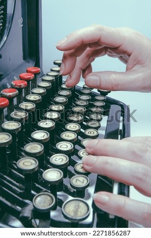 Woman's hands typing on a antique typewriter, interesting piece, mix of art, culture and historical engineering.
