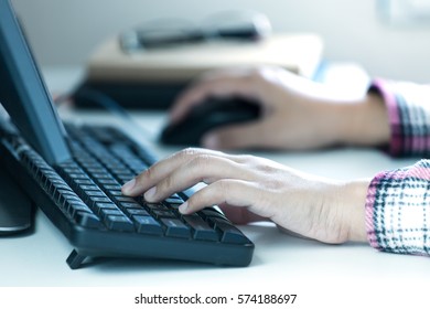 Woman's Hands Typing On Desktop Keyboard.