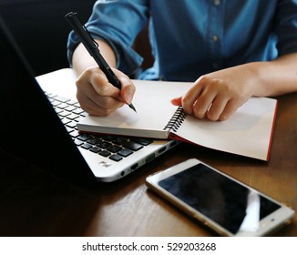 woman's hands typing on a laptop
