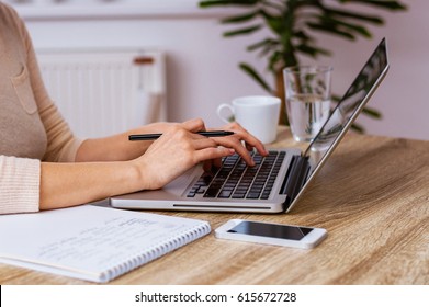 Woman's hands working on a lap top