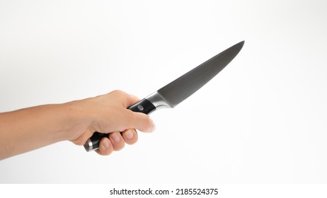 A Woman's Left Hand Holds A Kitchen Knife Blade Diagonally Upwards