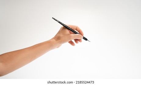 A Woman's Left Hand Holds A Pen For Calligraphy Gesture Writes