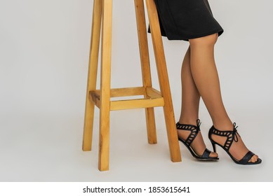 Woman's Leg And High Heel Shoes On White Background. Unfashionable, Outdated And Bad. Tights Under Sandals