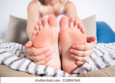 Woman's leg hurts, pain in the foot, massage of female feet at home