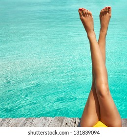 Woman's Legs At Beach Jetty