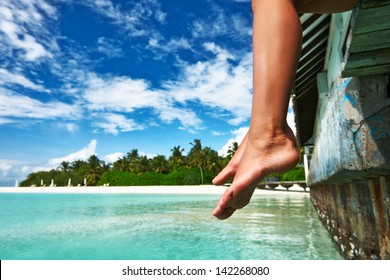 Woman's legs at beach jetty