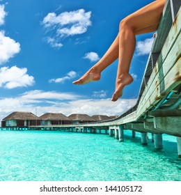 Woman's Legs At Beach Jetty