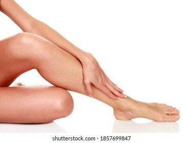 Woman's legs with clean and smooth skin on white background, isolated
