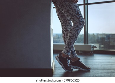 Woman's Legs In A Grey Sport Pants.