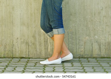 Woman's legs in jeans rolled up