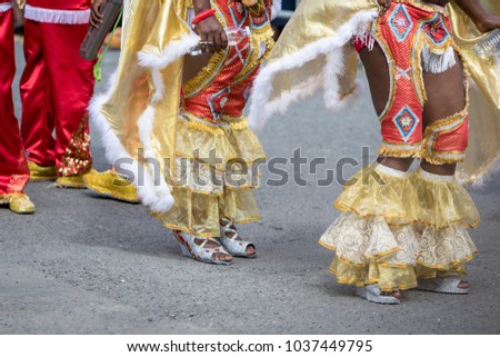 Woman's legs wearing masquerade mask during carnival parade in Guadeloupe, Caribbean