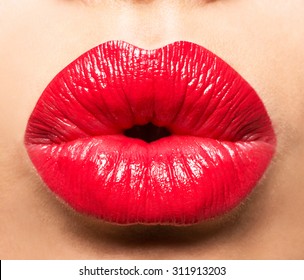 Woman's lips with red lipstick and  kiss gesture