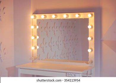 Woman's makeup place with mirror and bulbs