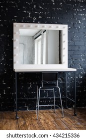 Woman's Makeup Place With Mirror And Bulbs At Photo Studio Loft Interior Black Brick Wall