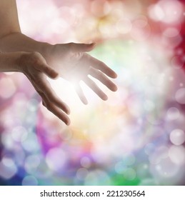 Woman's Outstretched Healing Hands With Light Bokeh Background And Ball Of White Energy Between