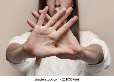 Woman's palm close up, gesture stop and don't move, stop domestic violence - Shutterstock ID 2210389669