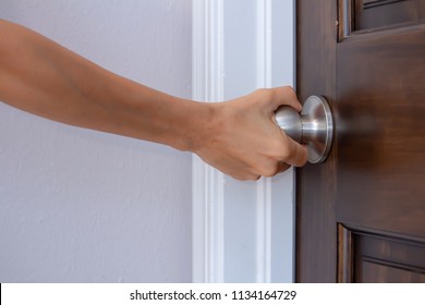 A Woman's Right Hand Turning A Doorknob To Close Or Open It Palm Turned Away From Camera, Privacy Trust Safety Security Concept, Horizontal Shot, White Copy Text Space, Closeup Side View