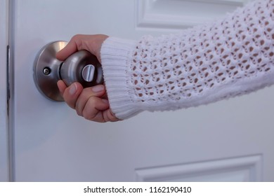 A Woman's Right Hand Turning A Doorknob To Close Or Open It, Privacy Trust Safety Security Insurance Protection Concept, Horizontal Shot, Copy Text White Space, Closeup Side View