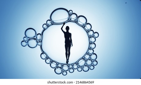 Woman's Silhouette Inside Macro Bubble On Blue Background | Body Care And Skin Moisturizing Concept