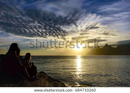 Womans silhuete at summer sunset in Ipanema beach, Rio de Janeiro