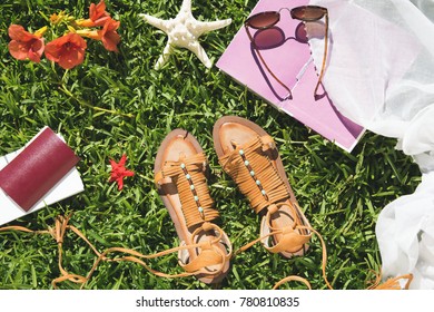 Woman's summer and travel accessories on grass