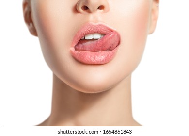 Woman's tongue seductively licking lips. Beautiful chubby lips. seduction concept
