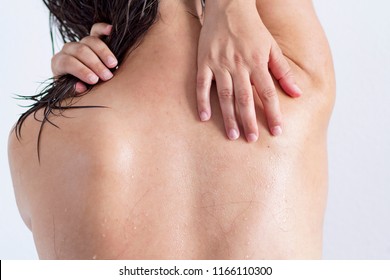 A woman's wet back with water drops