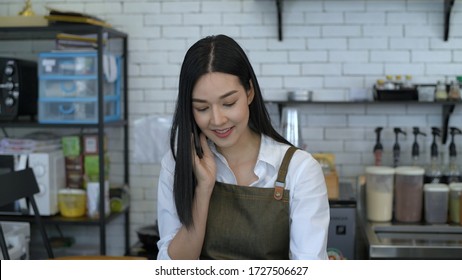 Women are accepting customer orders by phone within the counter. - Powered by Shutterstock