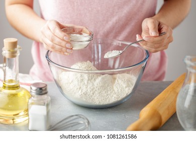 Women Adds The Baking Powder Into The Glass Bowl With Flour. Step By Step Recipe Of Homemade Mexican Flatbread Tortilla.