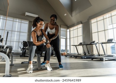 women African American plus-size coach training latina female dumbbell lifts weights exercise in gym. sport training weights fitness, Exercise to lose weight, take care of health. - Powered by Shutterstock