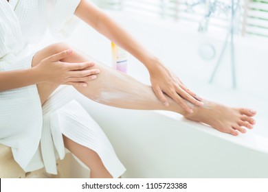 Women Are Applying Lotion To The Legs. After Bath