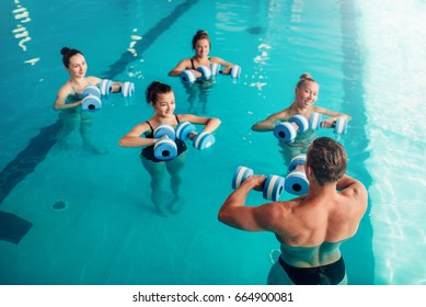 Women Aqua Aerobics Traninig With Dumbbells