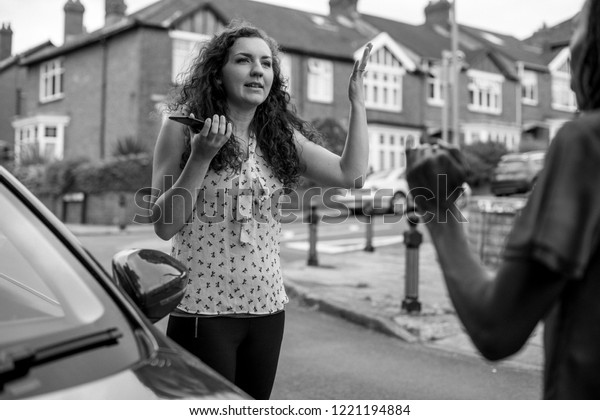 Women arguing after a car\
accident