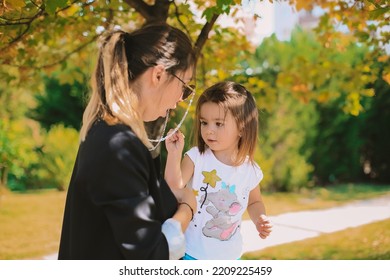 Women And Baby Girl. Mother And Daughter Autumn Photo Shoot. October Park. Family Photo Shoot.