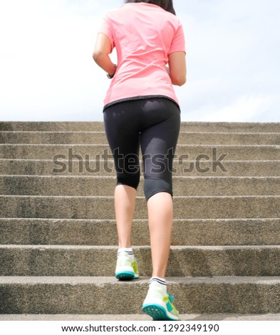 women beautiful running up the stairs, burn fat in the body. sky background.Healthy Lifestyle Concepts