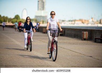 Women Biking In City 