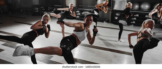 Women In Black And White Sportswear On A Real Group Workout In The Gym Train To Fight, Kickboxing With A Trainer