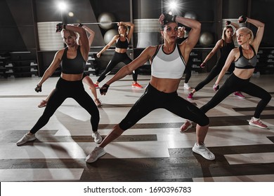 Women In Black And White Sportswear On A Real Group Body Combat Workout In The Gym Train To Fight, Kickboxing With A Trainer