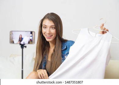 women blogger video blog youtuber reviewing shirt video live Streaming to social network by internet at home, beauty blogger concept  SME shop - Shutterstock ID 1487351807